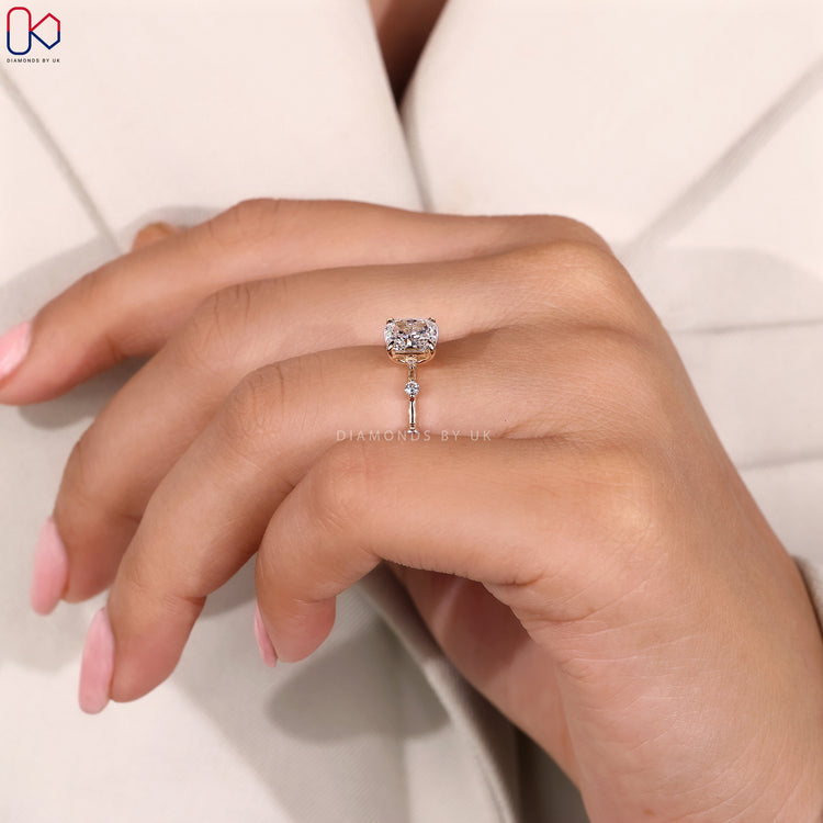 Four claw prong elongated cushion engagement ring.
