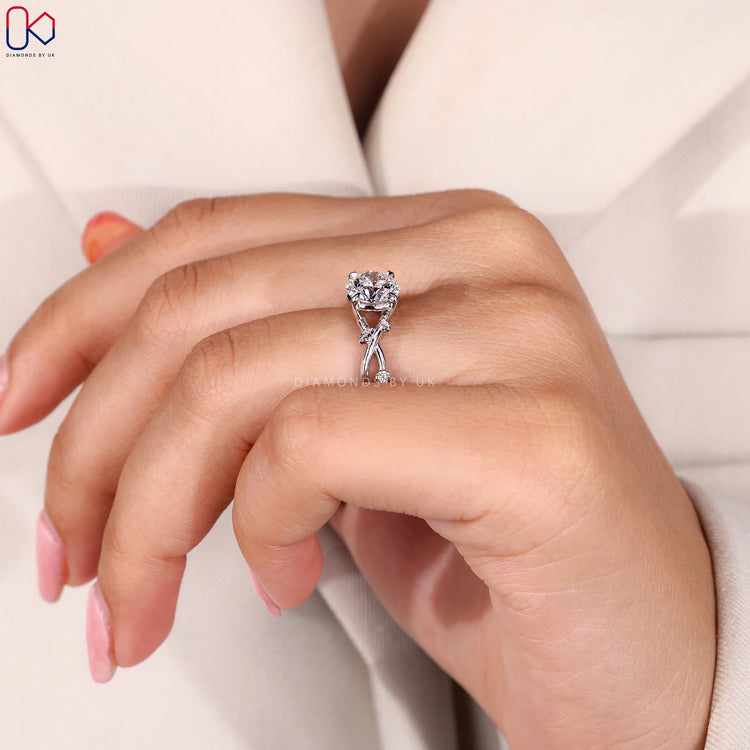 Twisted band diamond engagement ring with round centre stone.
