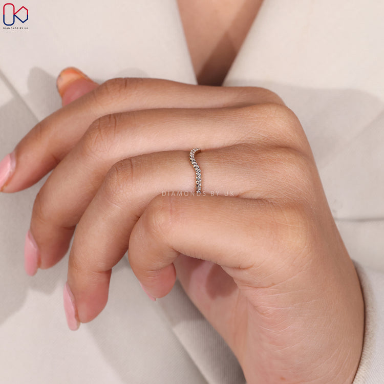 Yellow gold wedding band with curved design.
