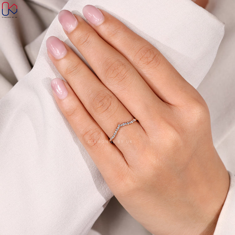 Yellow gold wedding band with curved design.
