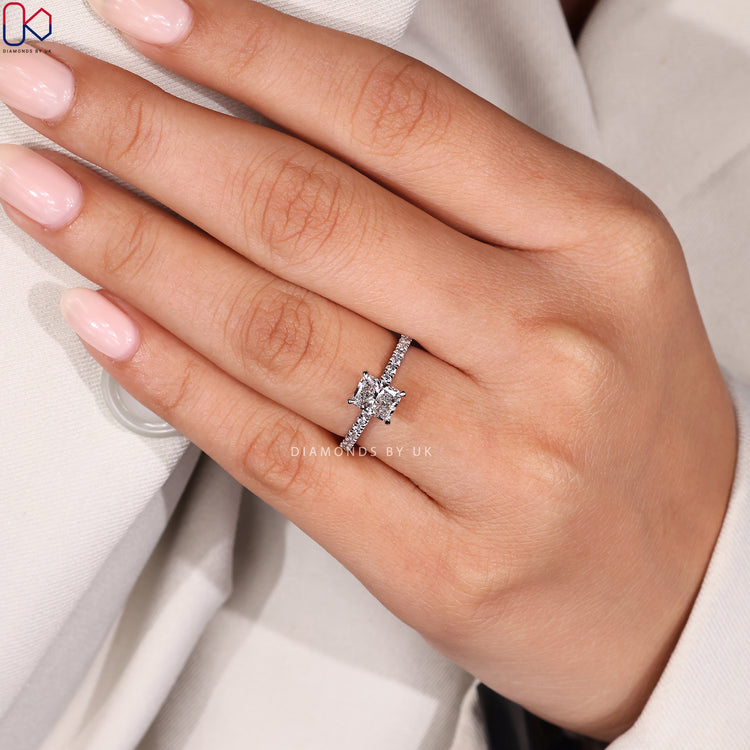 Prong setting radiant cut ring with round diamond accents.
