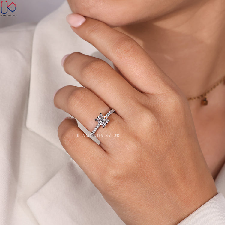 Radiant cut center diamond with pave side diamonds.

