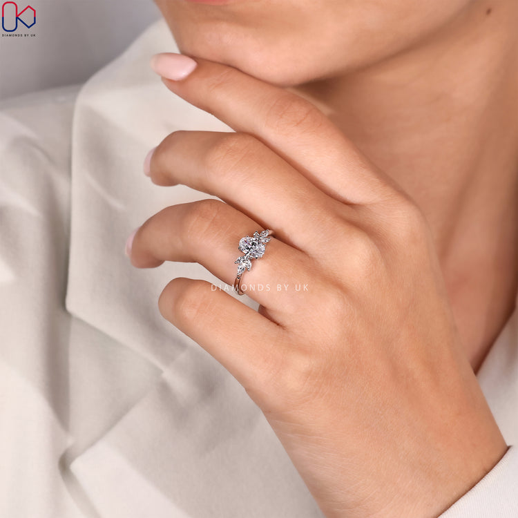 White gold ring with hidden halo and oval cut diamond.
