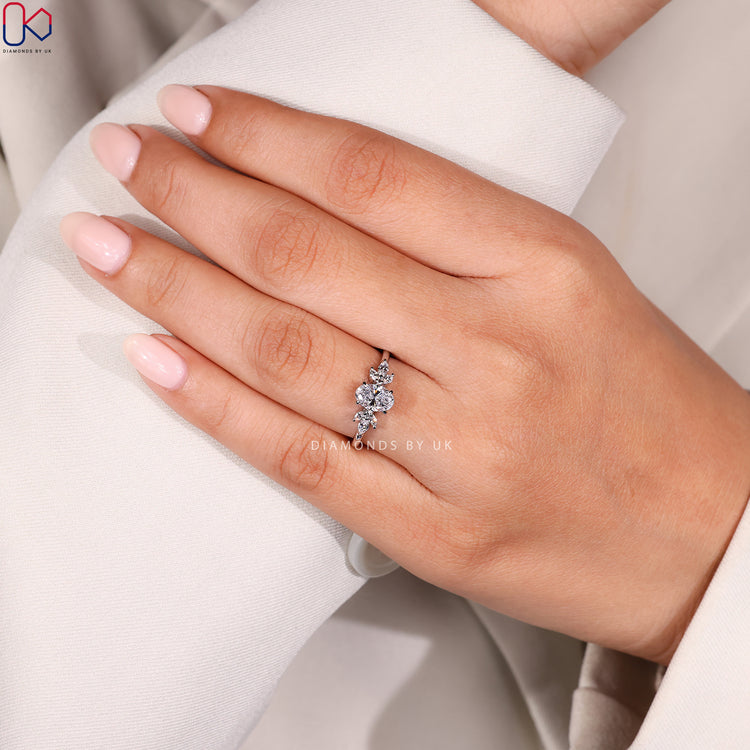 Hidden halo engagement ring with oval center diamond.
