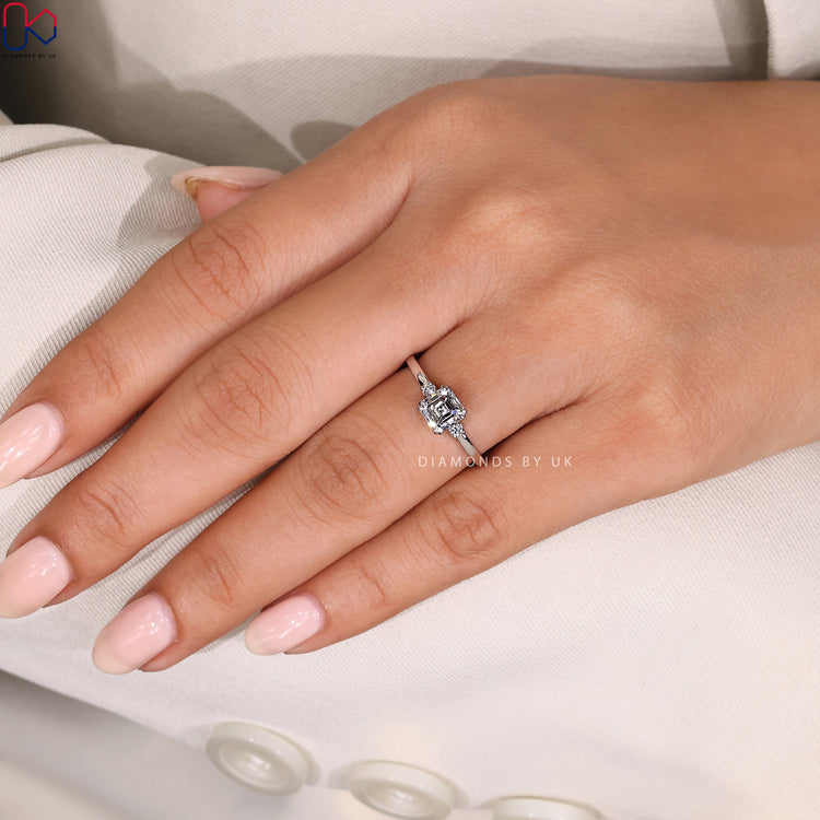 Asscher cut center stone with round diamond accents.
