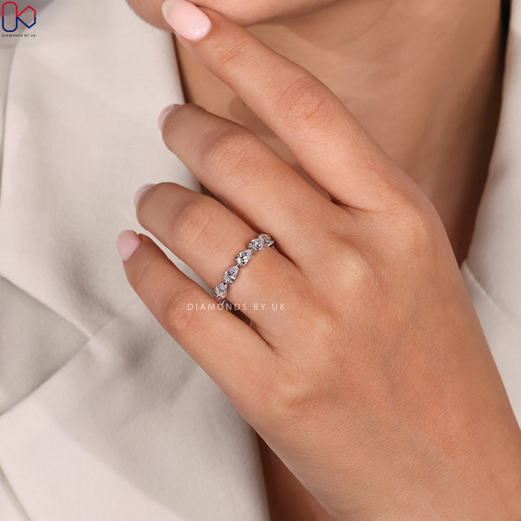 Pear diamond eternity band set in white gold.
