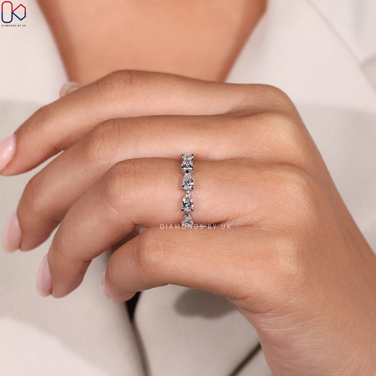 Close-up of claw prong setting on diamond band.
