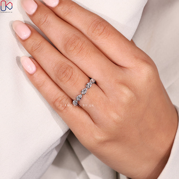 Overhead image of white gold eternity diamond band.
