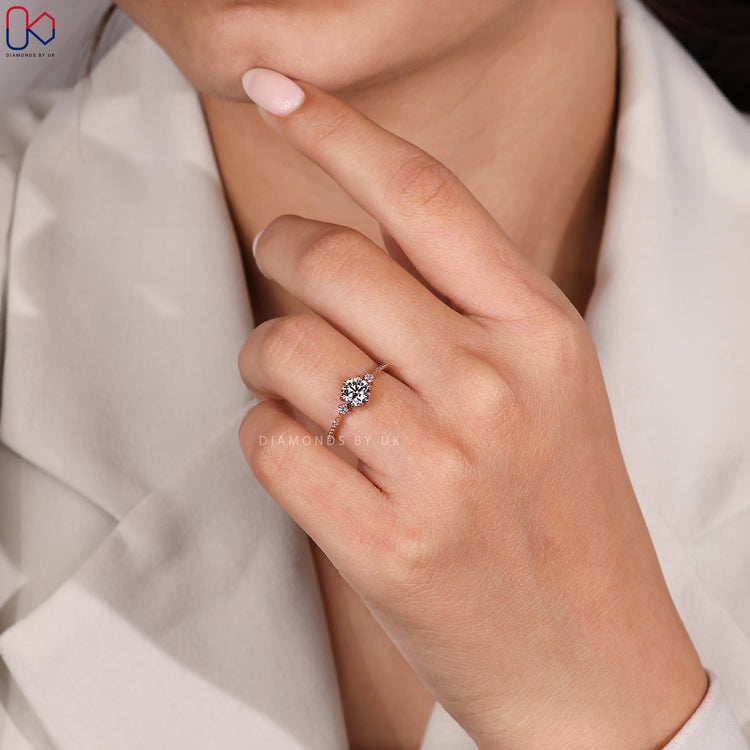 Rose gold engagement ring with round cut diamonds.
