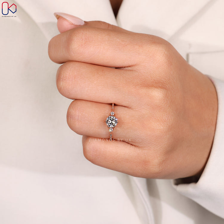 Round diamond engagement ring with milgrain detailing.
