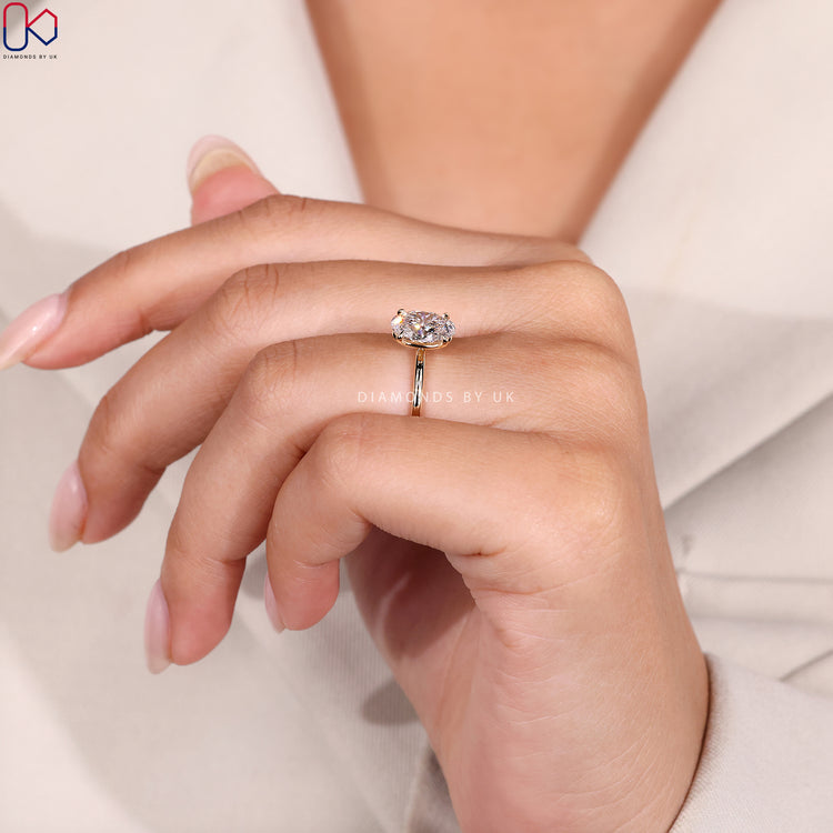 Oval solitaire diamond ring with minimal design.
