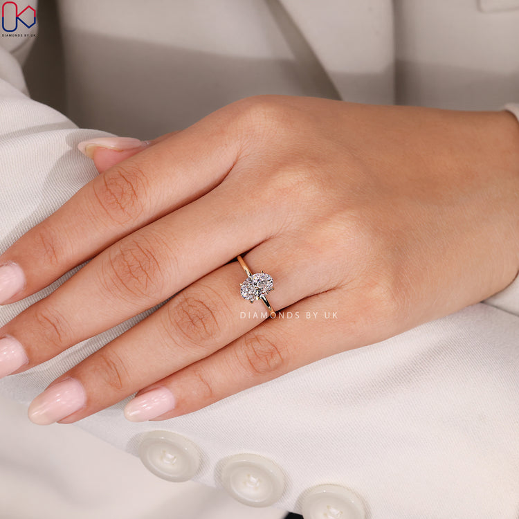 Yellow gold diamond ring with oval solitaire.
