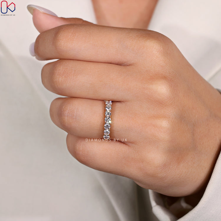 Round cut 7 stone band with prong setting band.
