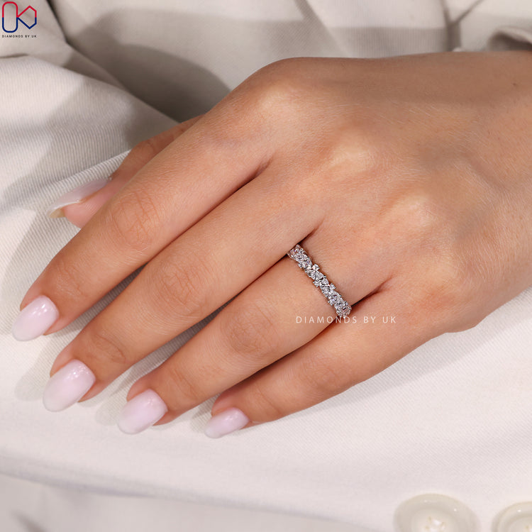 Handmade band with shared prong and white gold style.
