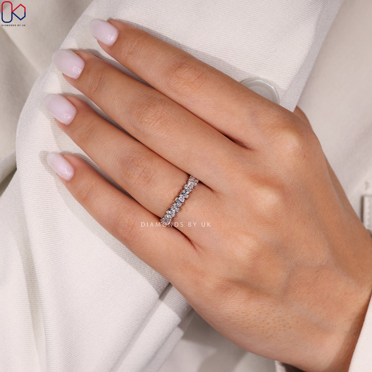 Round diamond band with pear and round stones.
