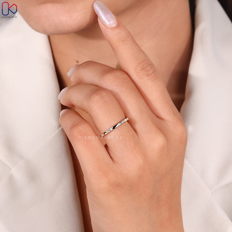 Simple minimalist wedding band in yellow gold with diamonds.
