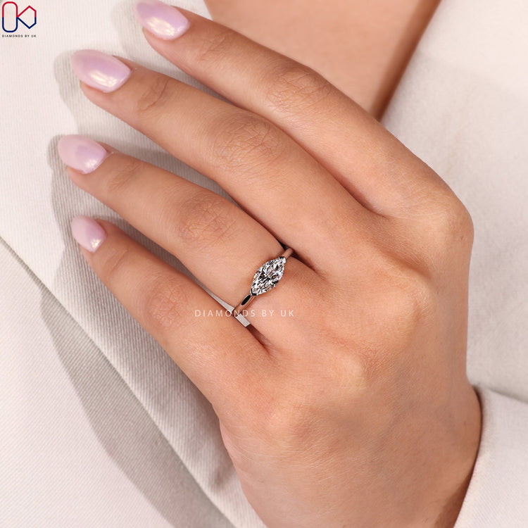 Custom white gold ring with marquise diamond center.
