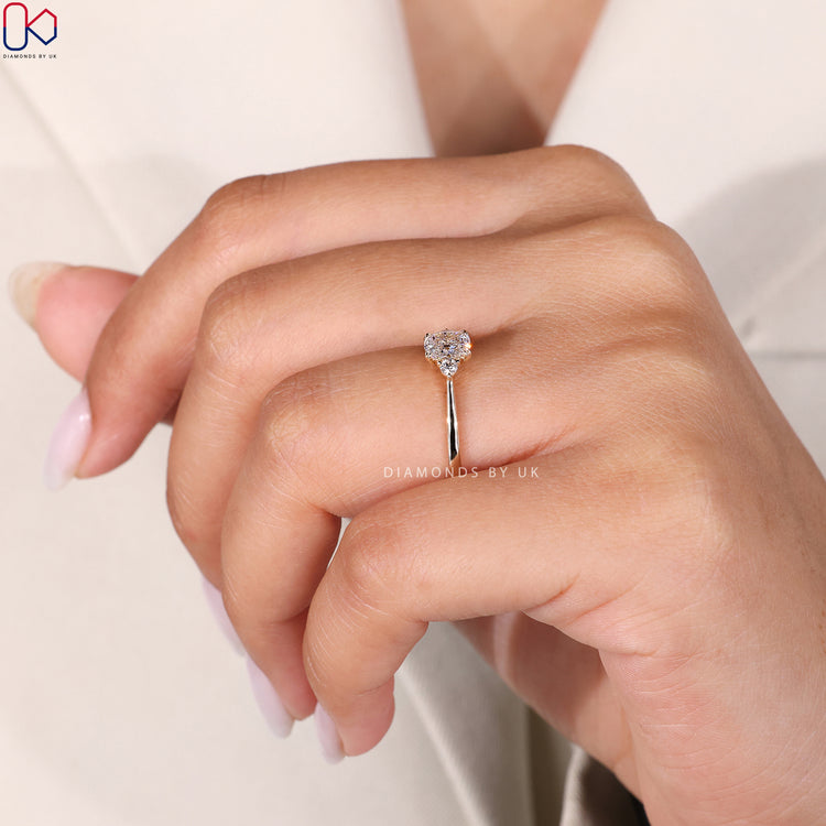 Buy engagement ring with cushion cut and round side stones.

