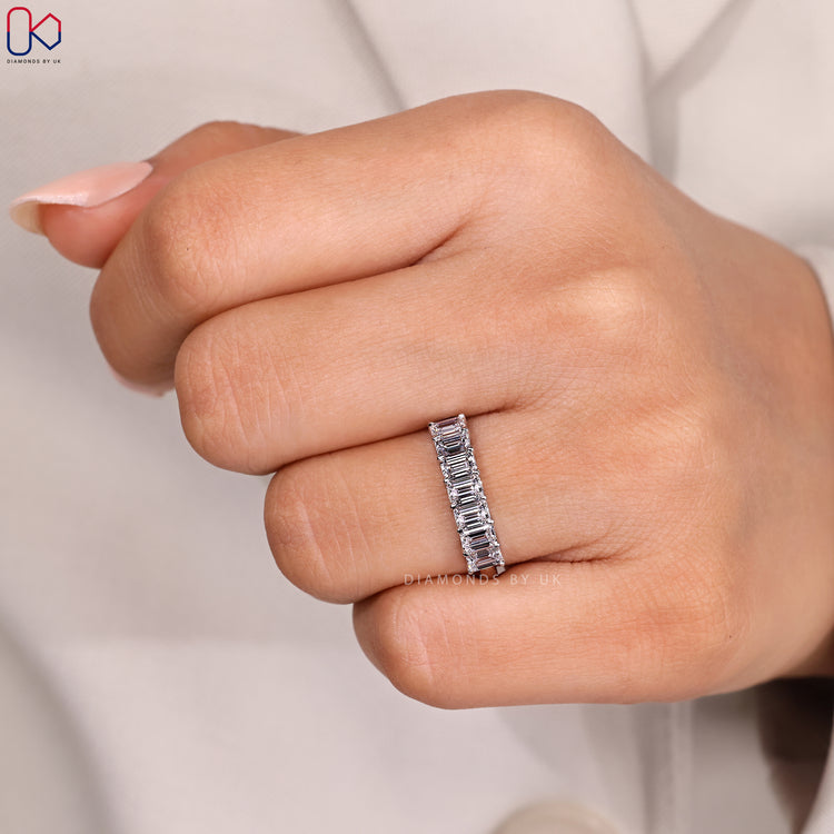 Half eternity wedding band with emerald cut stones.
