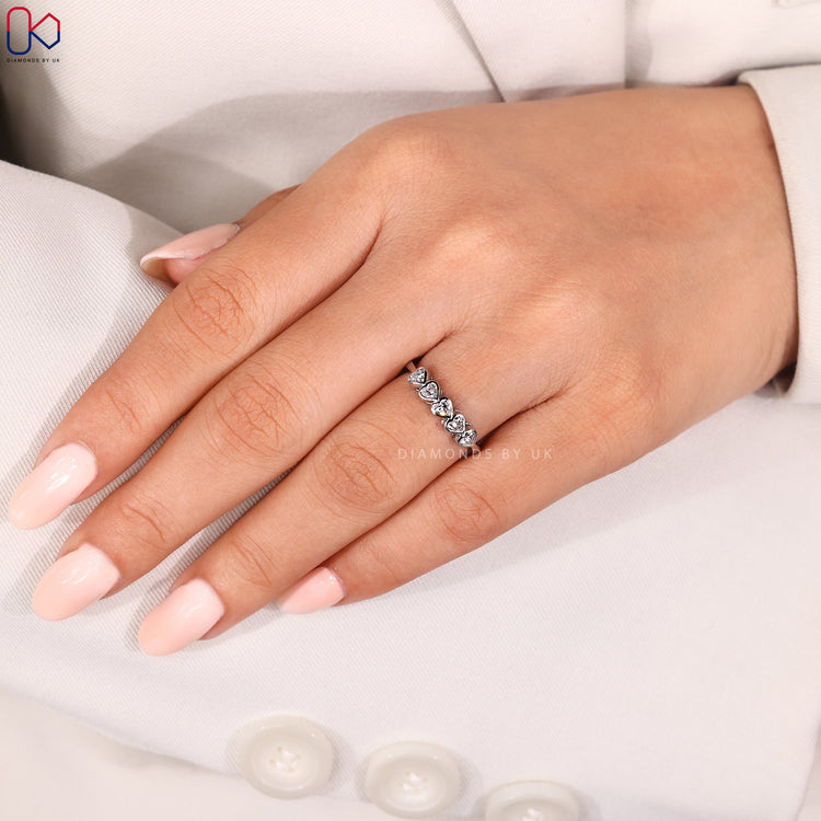 Heart-shaped diamond 5 stone wedding band.
