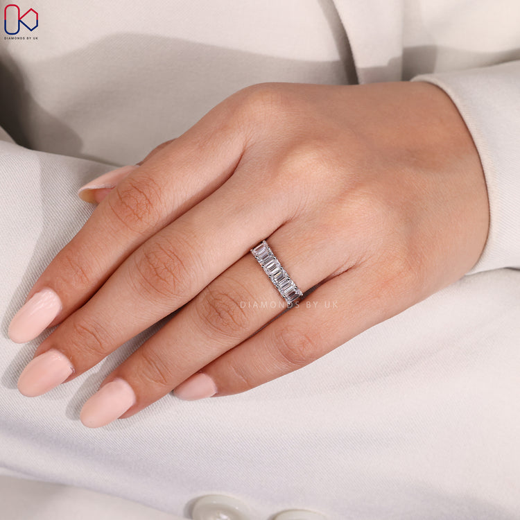 6 stone wedding band with emerald cut stones.
