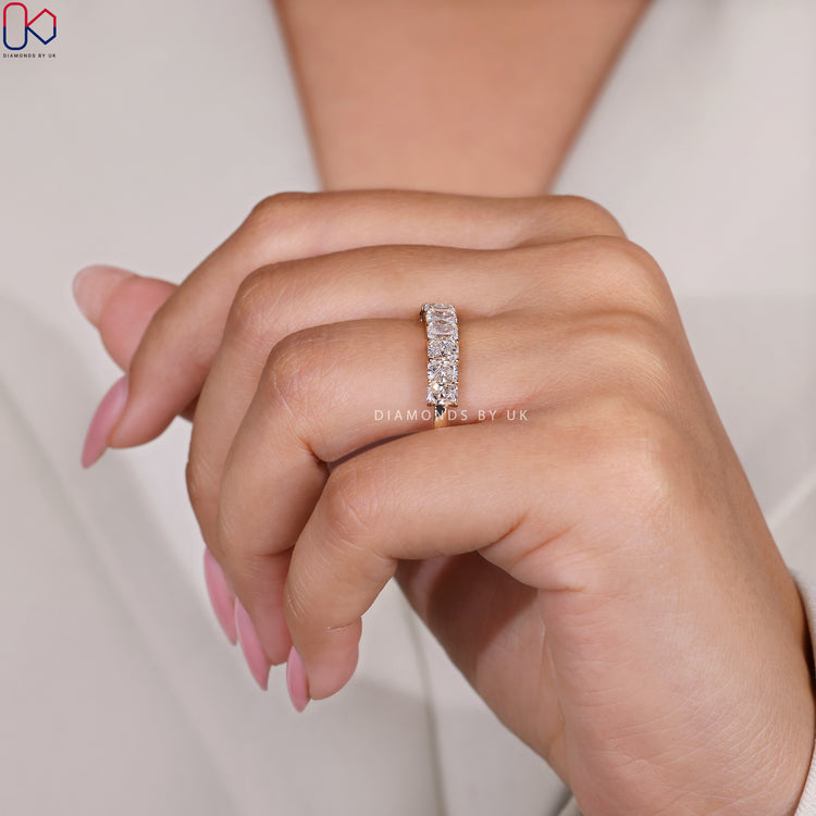 Half eternity radiant cut band in yellow gold handmade by Diamondsbyuk.
