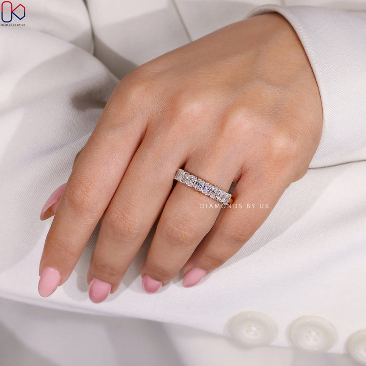 Yellow gold diamond band with prong setting for radiant cut stones.

