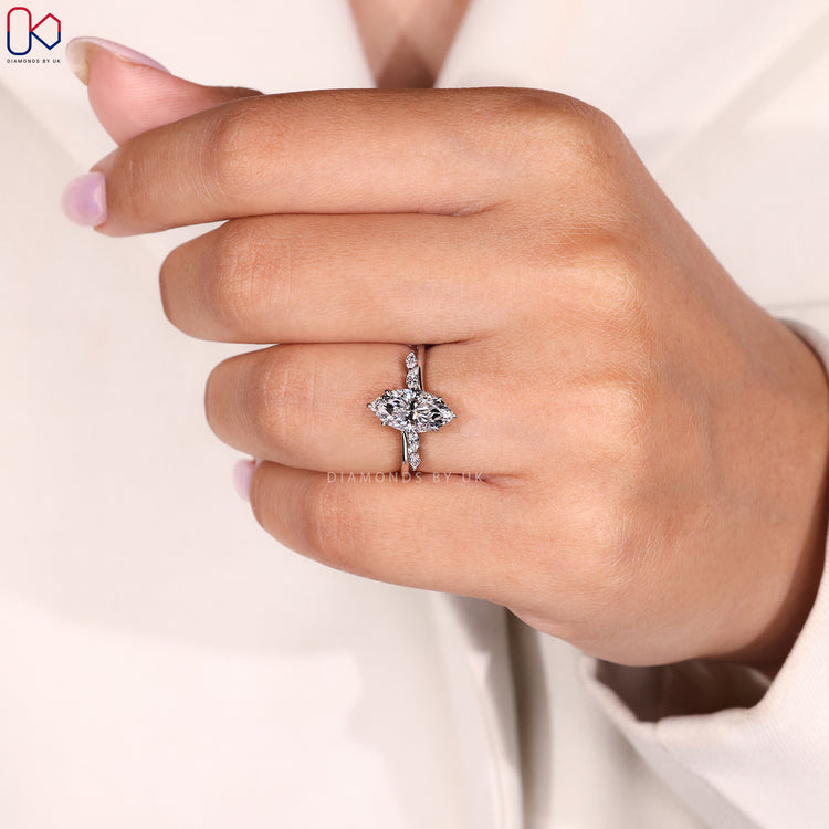 Hidden halo engagement ring with marquise cut diamond.

