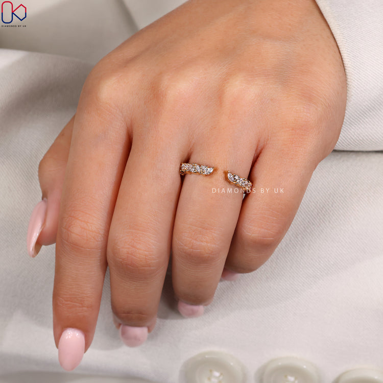 Marquise wedding band with round prong setting.
