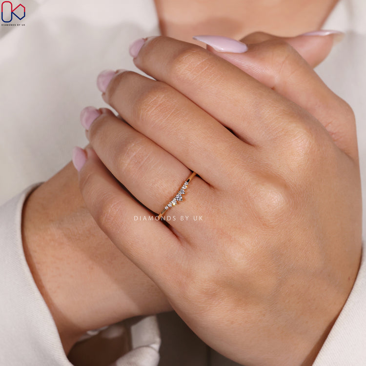 Yellow gold band featuring seven lab grown round cut diamonds.
