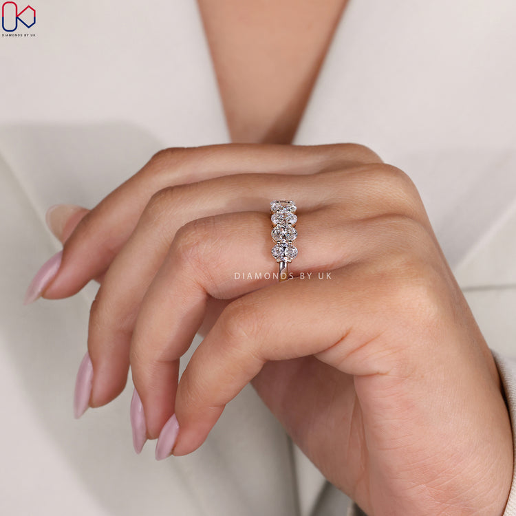 Buy diamond band with half eternity oval cut stones in yellow gold.
