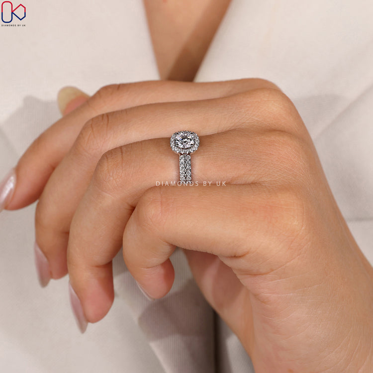 Halo setting ring with brilliant diamonds surrounding the centre stone.
