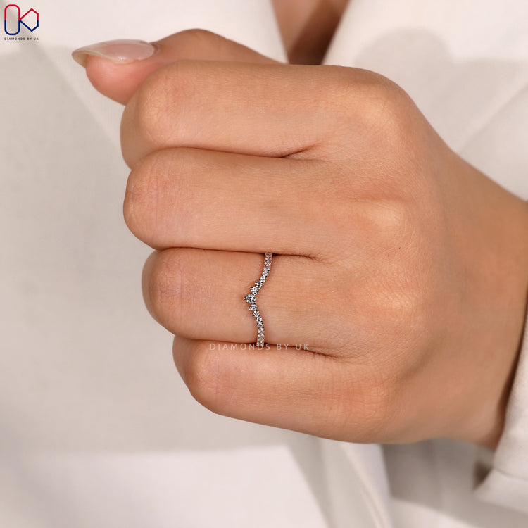 Prong setting wedding band with round diamonds.
