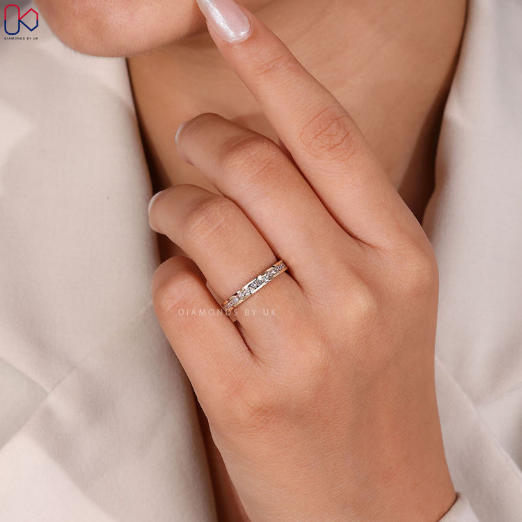 Round diamond wedding band in yellow gold.
