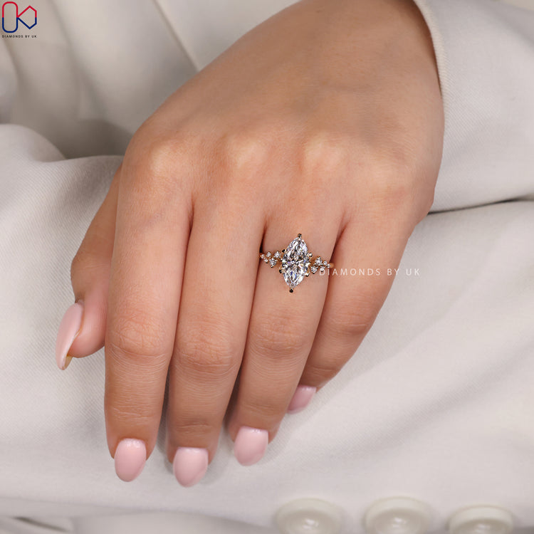 Yellow gold ring with marquise cut centre diamond.
