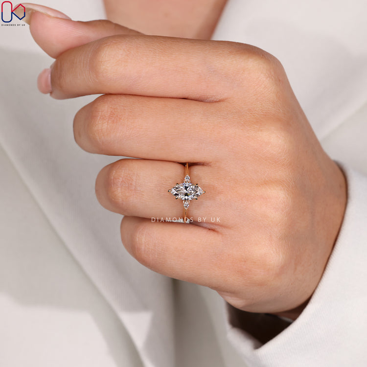 Marquise diamond engagement ring with three stone design.

