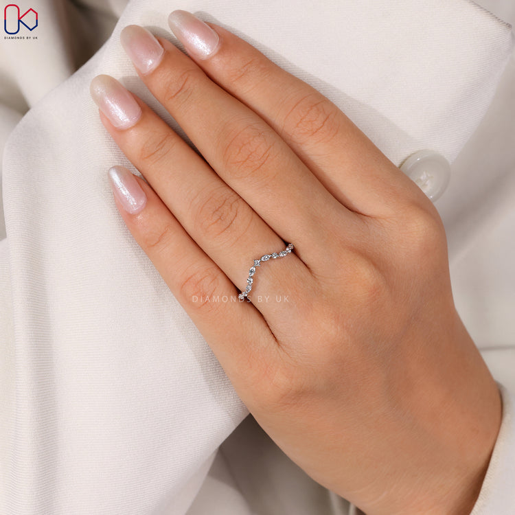 Half eternity wedding band with marquise and round diamonds.
