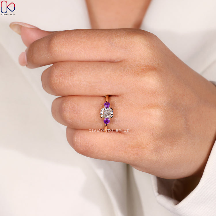 Three stone diamond engagement ring with cushion cut centre.
