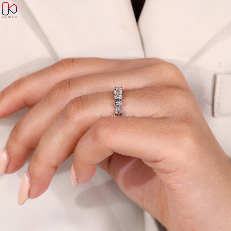 Prong setting wedding band with round stones.
