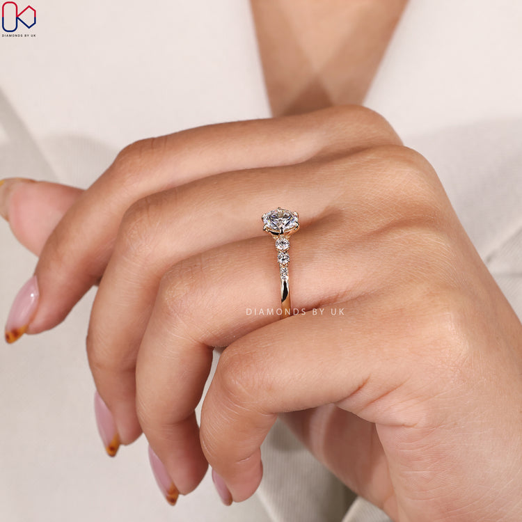 Diamondsbyuk ring with round center and side diamonds.
