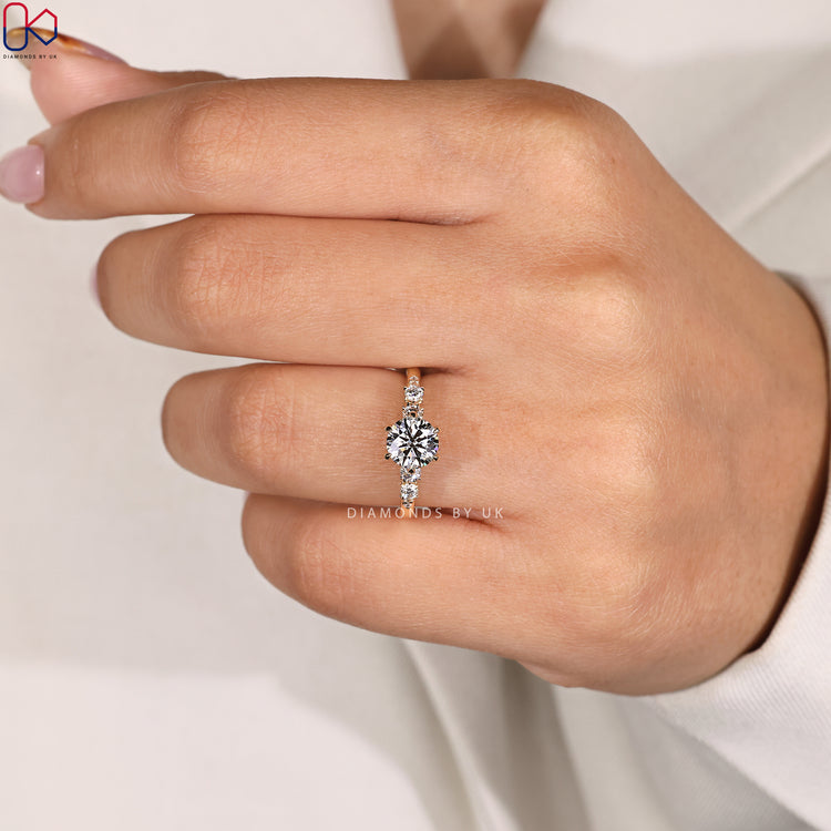 Yellow gold diamond ring with round center stone.
