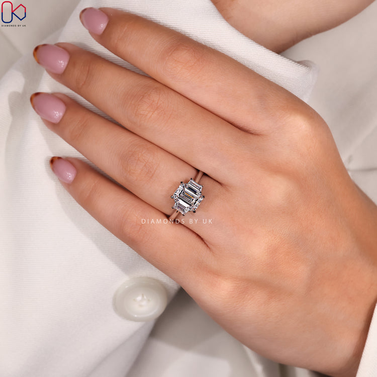 Handmade ring crafted with emerald centre and baguette sides.
