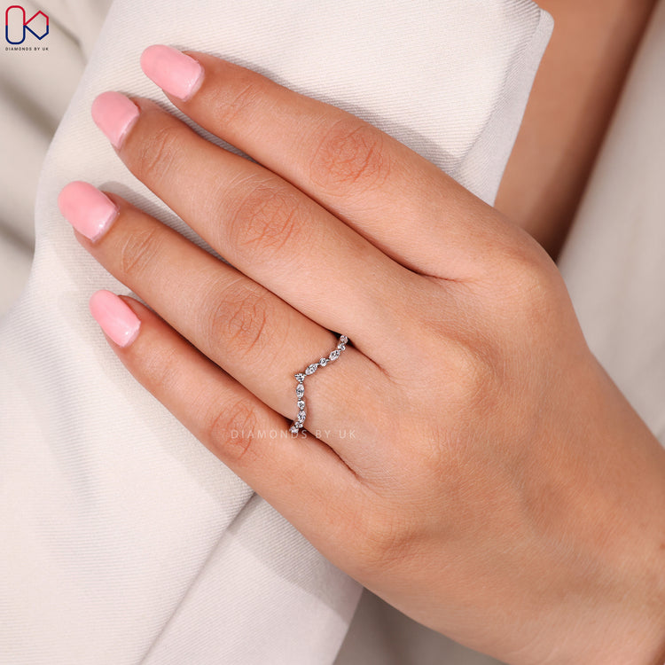 Curved diamond band with mixed shapes.
