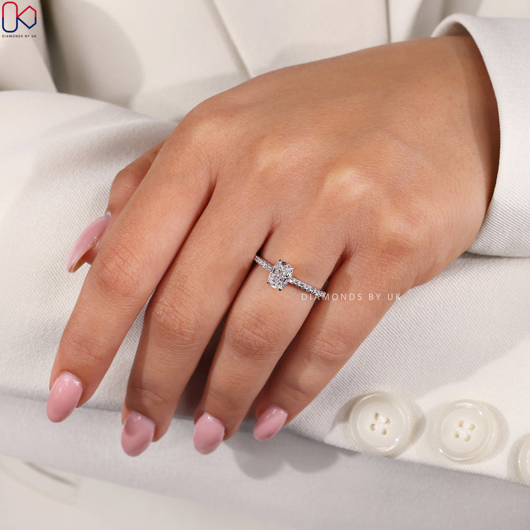 Hidden Halo Engagement Ring with a pave band setting, cushion diamond, and round side stones in white gold.
