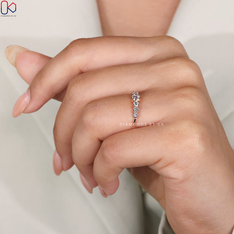 Handmade band featuring round diamonds and prong setting.
