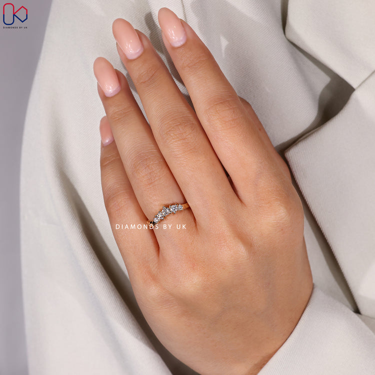 Curved twig-inspired diamond wedding band in yellow gold.
