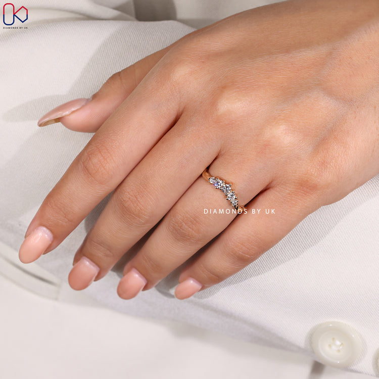 Custom handmade prong set diamond wedding band in yellow gold.
