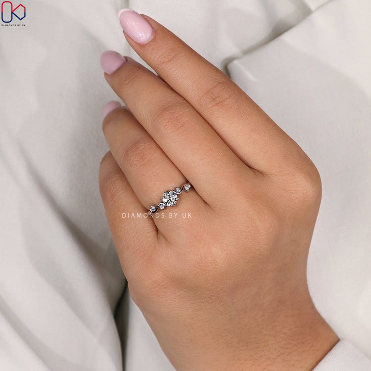 Vintage diamond engagement ring with side stones and lab grown centrepiece.