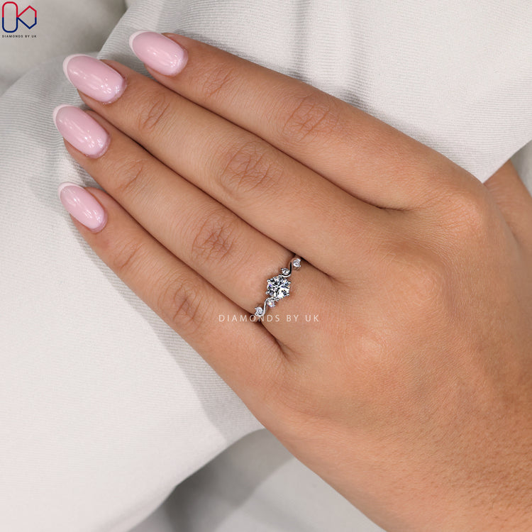 Handmade ring with vintage-style filigree work and secure side diamond accents.