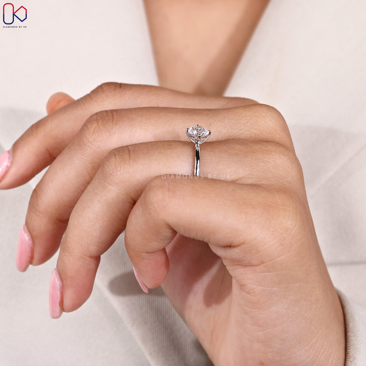 White gold engagement ring with round diamond.
